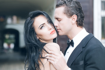 Handsome groom holds beautiful bride