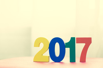 Happy New Year 2017 from wooden character, vintage color style