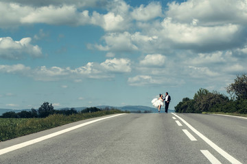 Married couple run along road