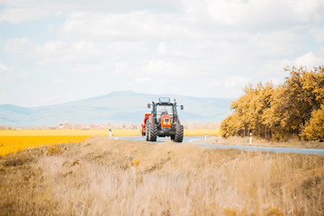 Farm tractor drives on road