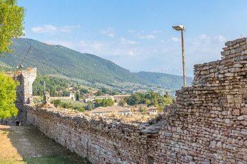 Assisi, Italy. The ruins of the fortress and the view of the city on a background of mountains