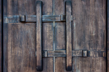 Closed wooden latch on aged wood door