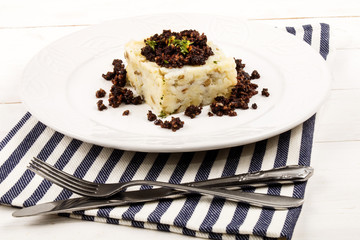 mashed potato and black pudding on a plate