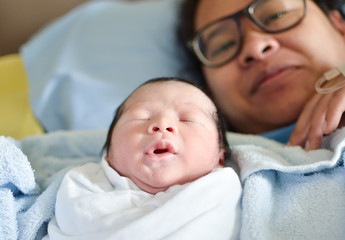 Asian mother with newborn baby in the hospital