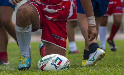 Rugby players scrum during a game, close up ball