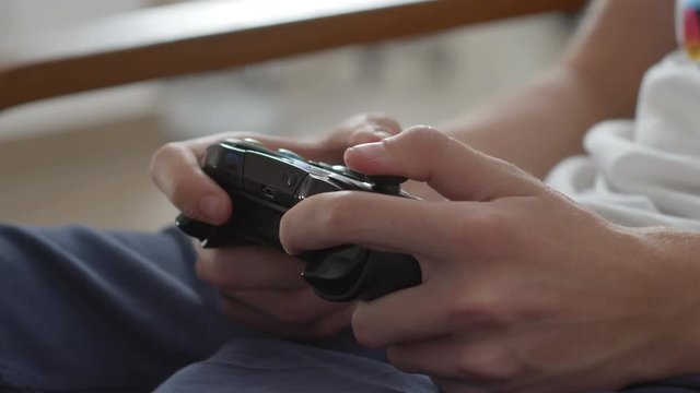 Close up of boy hands using game controller, in the end throwing the controller, angry close up