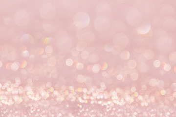Bokeh soft pastel pink background with blurred golden lights. Festive background.