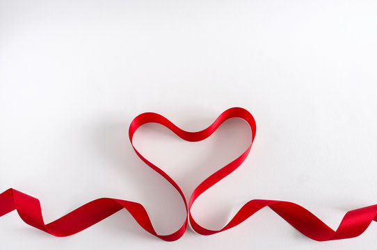 Valentine Heart. Red satin Ribbon. Isolated on white.