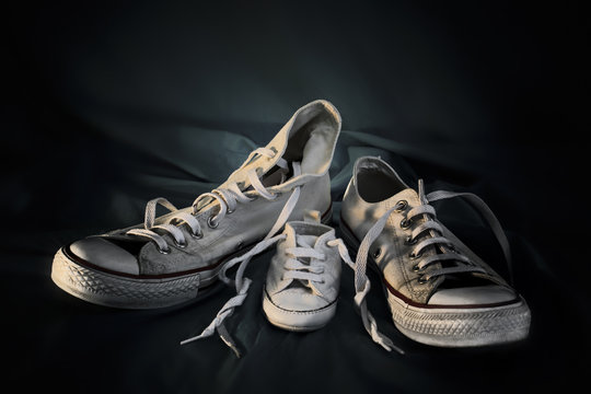 Sneakers Family-two different sneakers like symbol of mother and father and one small sneaker like symbol of child