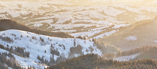 Winter Carpathian landscape with a village on the hills