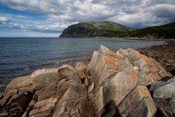 The sharp and angular rocks on the shore of the bay. Russia, Magadan region, The Sea of Okhotsk,...