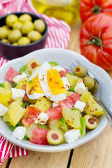 Potato salad with tomato, bell pepper, feta cheese and eggs