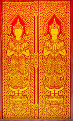 Angle Gold Paint on Red wood door in the northern temple ,Thailand.