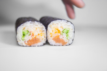sushi rolls set with man's fingers