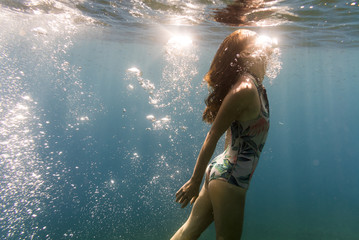 Side view young woman swimming in sea