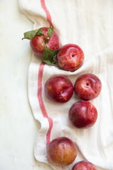plums on a white towel