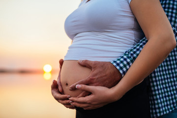 Holding her pregnant belly