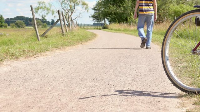 Man walking on rural road in beautiful scenic landscape, Sweden