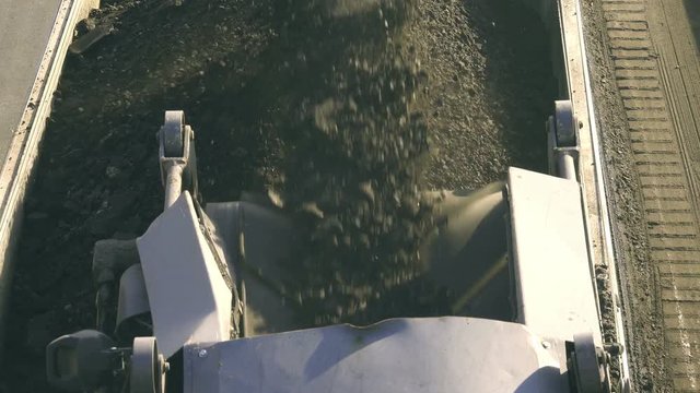 Cold milling machine, milled asphalt falls into the back of the truck, top view