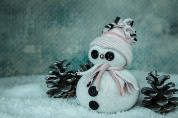 cute snowman figure and pine cone