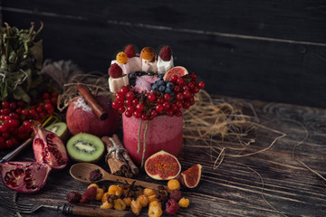 Fresh smoothie on wooden table in the glass