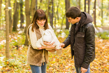 Fototapeta premium Portrait of a happy young couple playing with their cute newborn baby