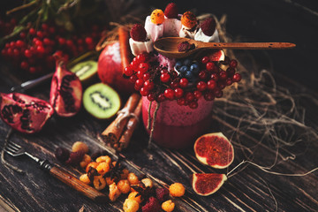 Fresh smoothie on wooden table in the glass