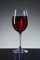 One wine glass on grey background