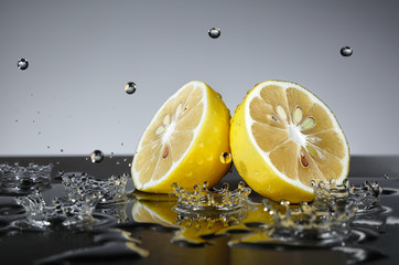 Fototapeta na wymiar Lemon with water drops on grey background
