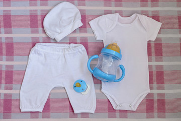 Set for newborn bodysuit pants cap and nipple with sippy cups .