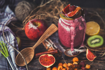 Fresh smoothie on wooden table in the glass