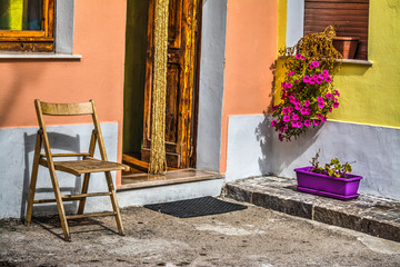 Fototapeta na wymiar wooden chair and flower pots