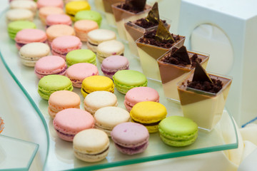 Desserts choice. Chocolate muffins, cookies and biscuits in glass jar on counter bar for sale.