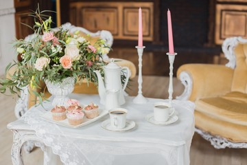 Wedding decorations zone - white table with bouquet and cupcakes