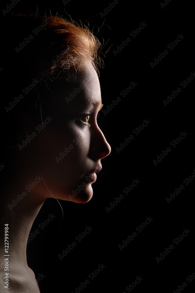 Wall mural profile of young pensive woman