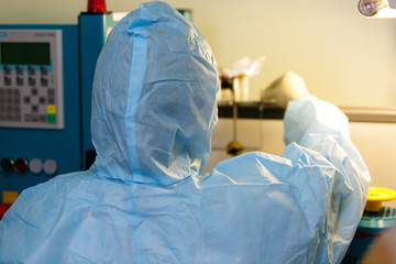 Scientists in protective suits in the 