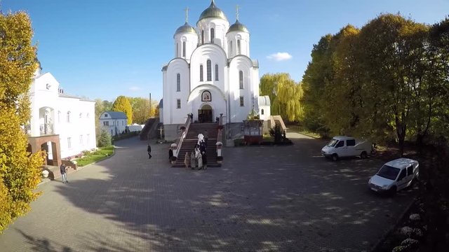 Newlyweds entering the church aerial view