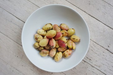 Freshly picked pistachio nuts in their outer shell
