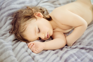 Close-up portrait of a beautiful sleeping baby. Cute infant kid. Child portrait in pastel tones. The beautiful baby could be a boy or girl