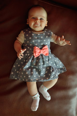 cute smiling baby girl lying in the bed. Toned photo with color filters