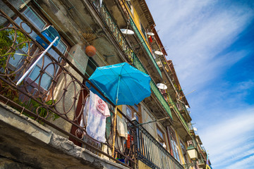 Drying laundry and sun umbrella on the street of Porto, Portugal