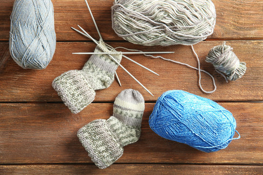 Knitting wool and knitting needles on wooden table