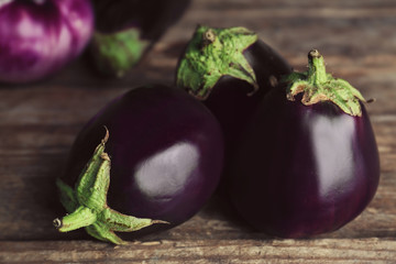 Fresh eggplants on wooden background