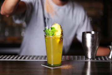 Barman preparing cocktail on bar counter