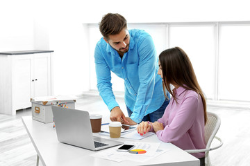 Obraz premium Beautiful woman and handsome man working in modern office