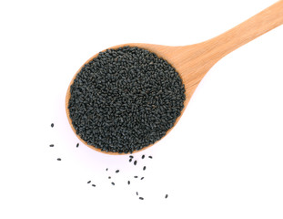 top view of black sesame seeds in wooden spoon isolated on white