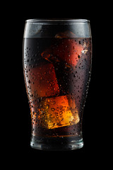 Cola glass with ice cubes and droplets