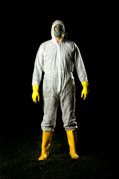 man in bio hazard protective suit with gas mask and gloves