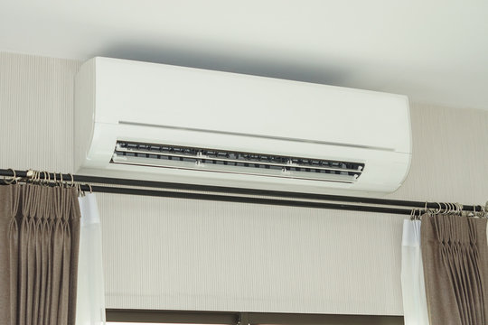 air conditioner installed on the wall under the ceiling