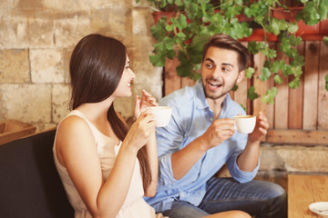 Beautiful young couple drinking coffee on date